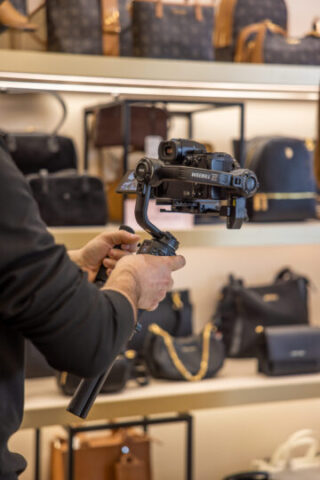 Close up of professional camera filming fashion products during commercial video production